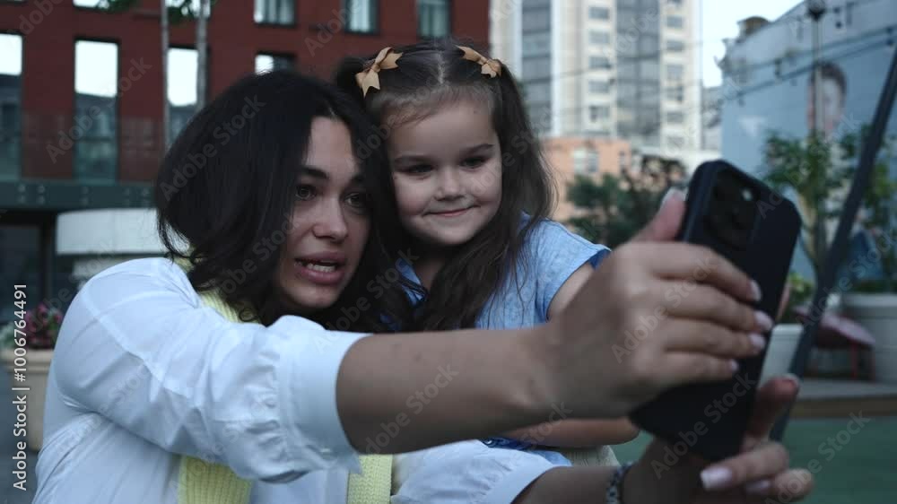 Mother and daughter enjoying fun moments together in the city park Mother and daughter enjoying fun moments together in the city park