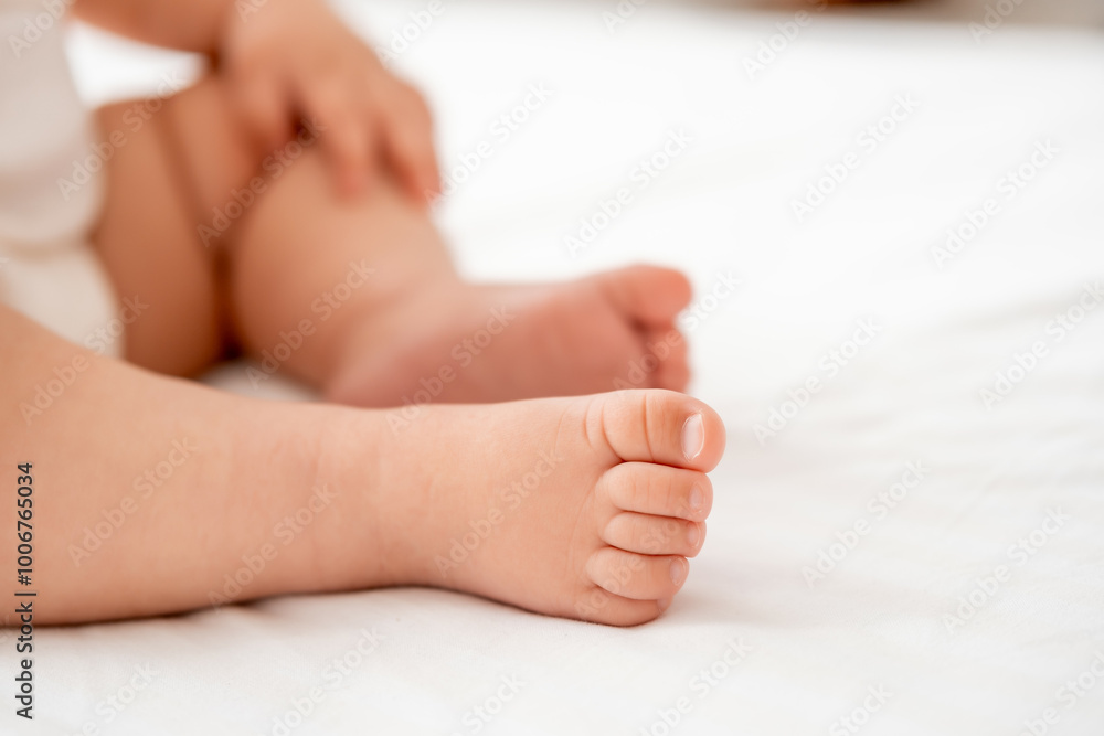 the legs of a small child on a white background on the bed, a pl the legs of a small child on a white background on the bed, a pl