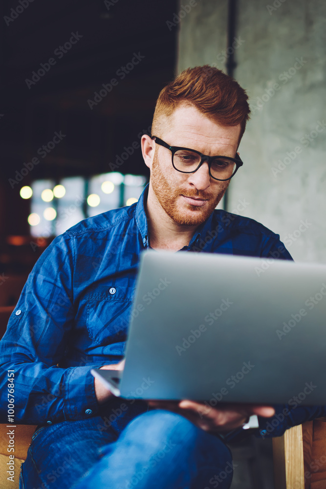 Serious businessman searching information for organisation meeting event with partners using free wifi connection on laptop device, concentrated freelancer reading news about antivirus application Serious businessman searching information for organisation meeting event with partners using free wifi connection on laptop device, concentrated freelancer reading news about antivirus application