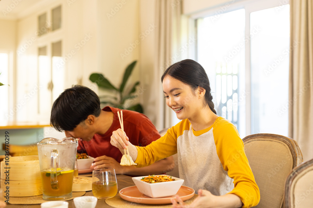 Eating lunch together, young asian brother and sister enjoying meal dining table Eating lunch together, young asian brother and sister enjoying meal dining table