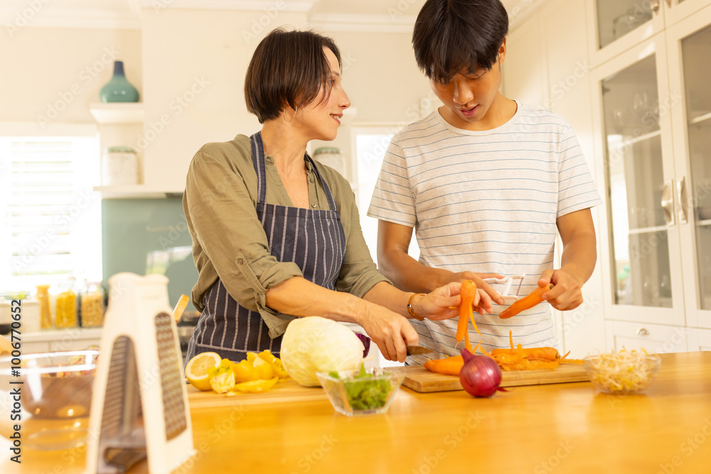 Cooking in kitchen, mother and teenage son preparing vegetables, bonding over meal prep Cooking in kitchen, mother and teenage son preparing vegetables, bonding over meal prep
