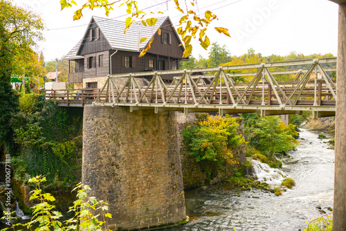 bridge over the river in the Village Rastoke with waterfalls of Korana river, Croatia. Old water mills on waterfalls. Beautiful landscape with waterfalls 