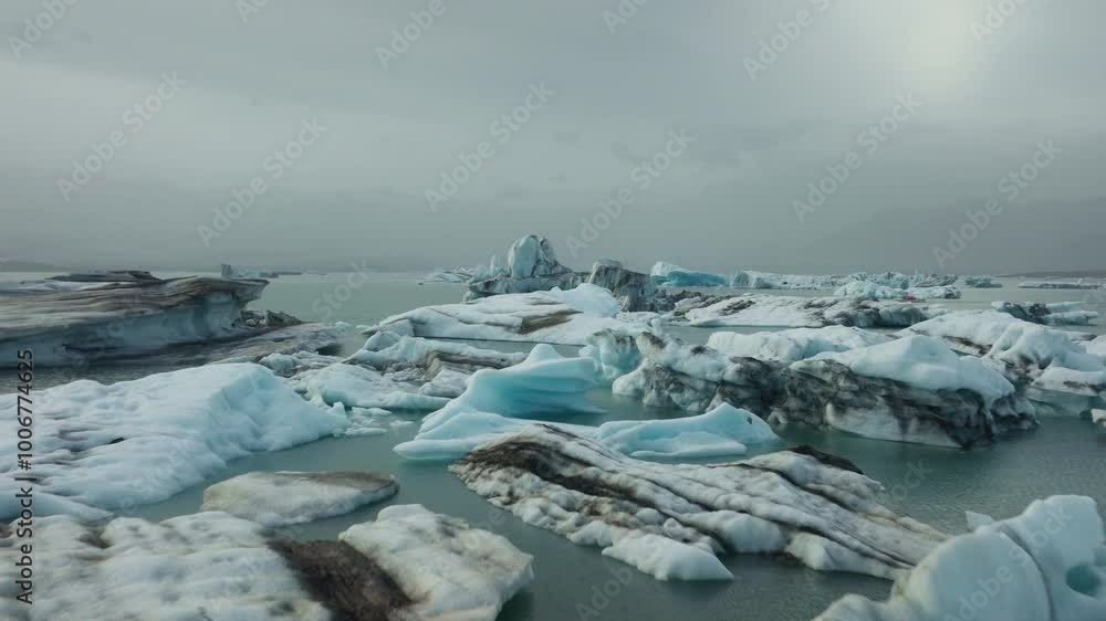 Aerial drone flight by icebergs and glaciers in Jökulsárlón Glacier lagoon, summer in Iceland. Aerial drone flight by icebergs and glaciers in Jökulsárlón Glacier lagoon, summer in Iceland.