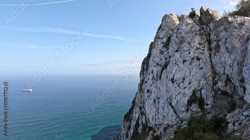 Dramatic view along the summit ridge of white Rock of Gibraltar. Clouds passing by rapidly. The Bay of Algeciras and La Linea, seen from the Rock of Gibraltar.