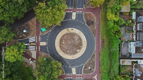 Top down aerial of roundabout with bicycle lanes under construction in a small Dutch town - drone ascending photo