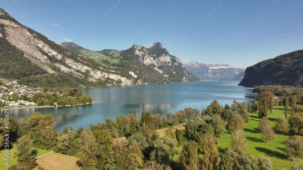 A captivating aerial view reveals Lake Walensee, framed by the charming landscape of Weesen, Glarus, Switzerland. A captivating aerial view reveals Lake Walensee, framed by the charming landscape of Weesen, Glarus, Switzerland.