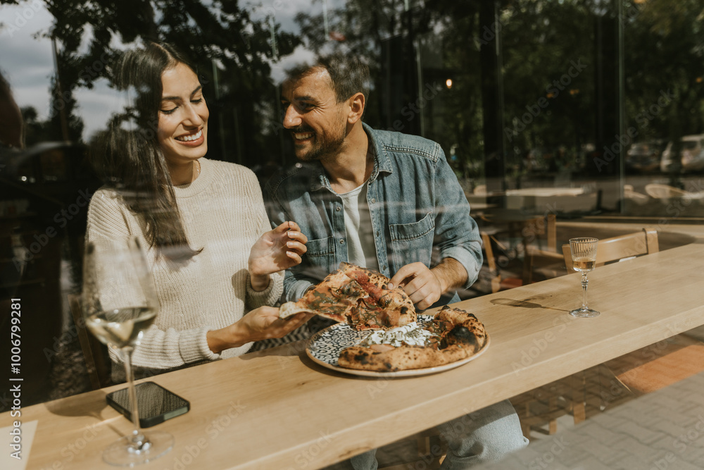 Enjoying delicious pizza together at a cozy café in the afternoon sunlight, sharing laughter and a wonderful meal Enjoying delicious pizza together at a cozy café in the afternoon sunlight, sharing laughter and a wonderful meal