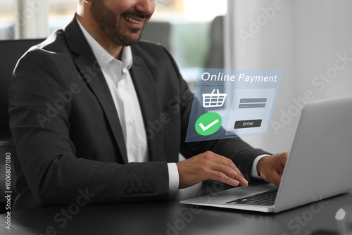 Online payment system interface over computer. Man working on laptop at desk in office, closeup