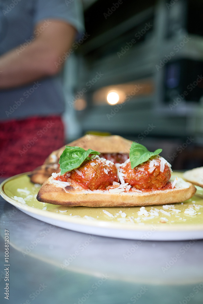 A hearty sandwich made with a pizza dough base, baked to perfection and filled with two perfectly assembled meatballs A hearty sandwich made with a pizza dough base, baked to perfection and filled with two perfectly assembled meatballs