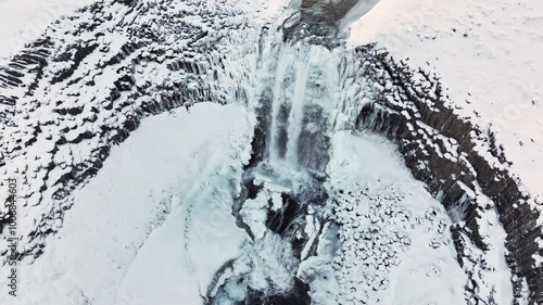 Waterfall in Iceland, Frozen river in winter, Magical location of snow and ice, Magical winter landscape in the northern country, Svodufoss photo