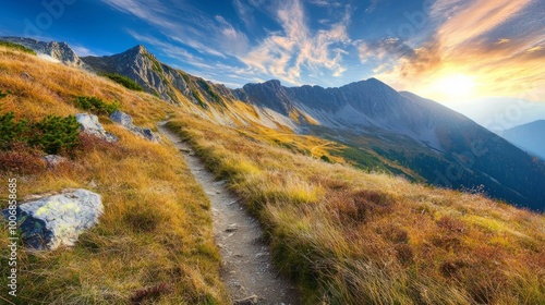 Mountain trail leading along the mountain ridge of beautiful mountains with autumn grass and colorful sky. Western Tatras, High Tatras, Slovakia, Poland. Discovering hiking in a colorful autumn., 