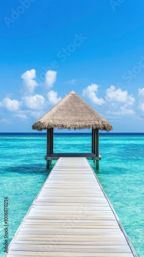 Beautiful blue sea and a wooden pier with a thatched roof on a tropical island.