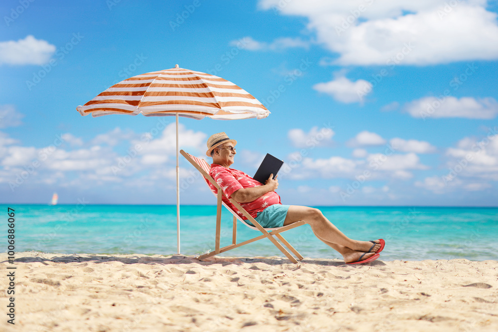 Man sitting on a sun lounger and reading a book by the sea Man sitting on a sun lounger and reading a book by the sea