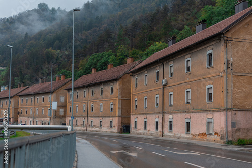 Obraz na płótnie Typical houses in downtown trbovlje. Brick brown houses are a typical sight when entering Trbovlje. Houses for miners and workers, rainy day. w salonie
