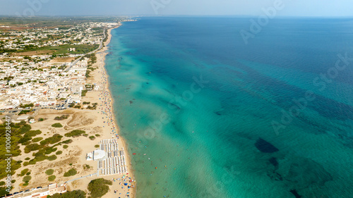 Aerial view of San Pietro in Bevagna in Salento. It is a small seaside town in the province of Taranto, Puglia, Italy. The water has Caribbean colors. photo