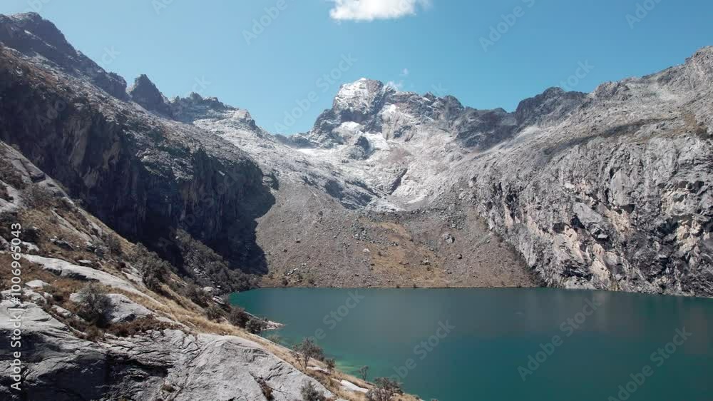 The Churup Lagoon with Turquoise Waters at the Foot of the Snow-Capped Cordillera Blanca is Located in the Huascaran National Park, in Ancash, Peru The Churup Lagoon with Turquoise Waters at the Foot of the Snow-Capped Cordillera Blanca is Located in the Huascaran National Park, in Ancash, Peru
