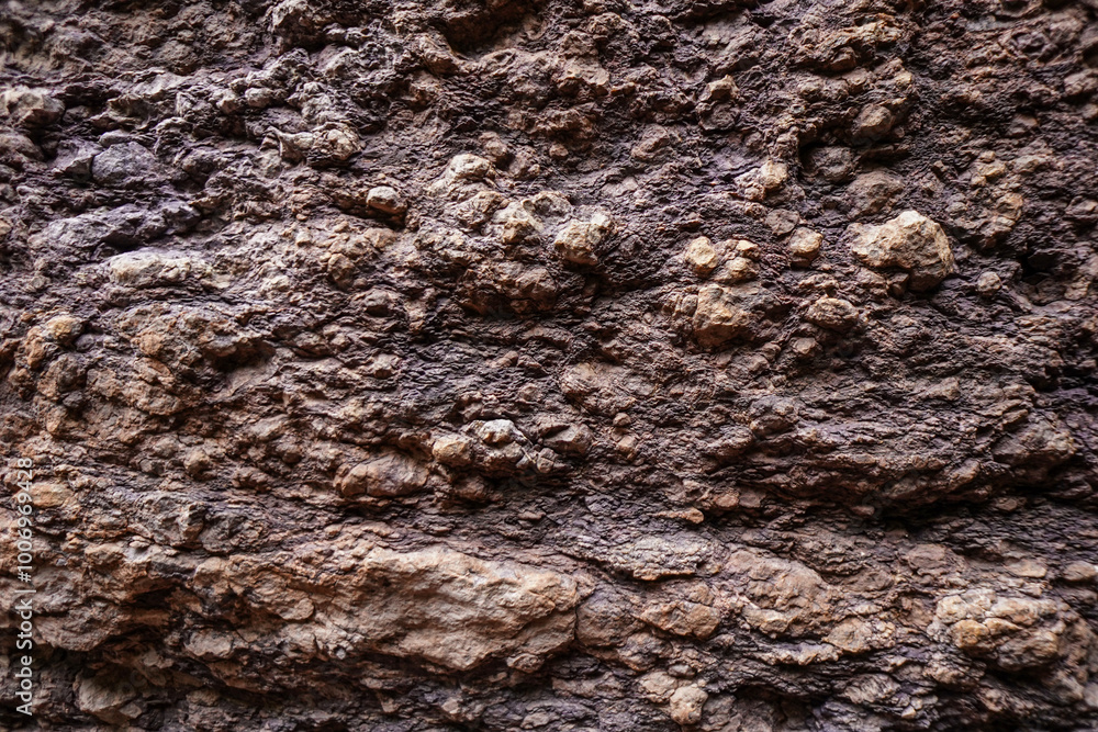 Brown rough stone wall for abstract background and texture for interior or exterior design. Beautiful patterns, space for work, banner, wallpaper close up. Brown rough stone wall for abstract background and texture for interior or exterior design. Beautiful patterns, space for work, banner, wallpaper close up.