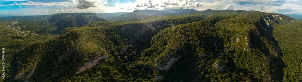 Obraz premium aerial panorama view of mountain range in Western Caucasus near Mezmay village with view of Lago-Naki plateau surroundings on sunny summer day
