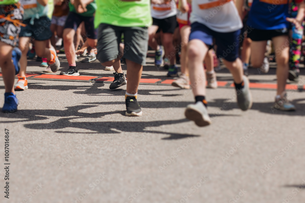 Children marathon runners crowd, young teen sportsmen participants start running in the city streets, crowd of kids joggers in motion, kid group athletes outdoor run, family competition in summer day Children marathon runners crowd, young teen sportsmen participants start running in the city streets, crowd of kids joggers in motion, kid group athletes outdoor run, family competition in summer day