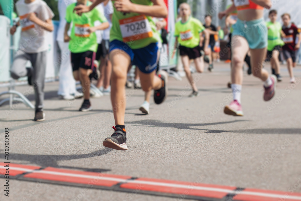 Children marathon runners crowd, young teen sportsmen participants start running in the city streets, crowd of kids joggers in motion, kid group athletes outdoor run, family competition in summer day