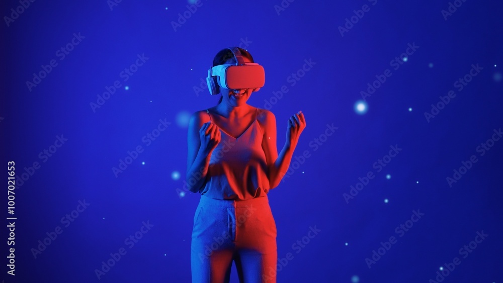 Naklejka premium Woman player using VR glasses transfer to fantastic metaverse game to fist up to be winning fantasy gaming space with lighting bokeh blue smoke meta 3D cyberspace technology meta world. Hallucination.
