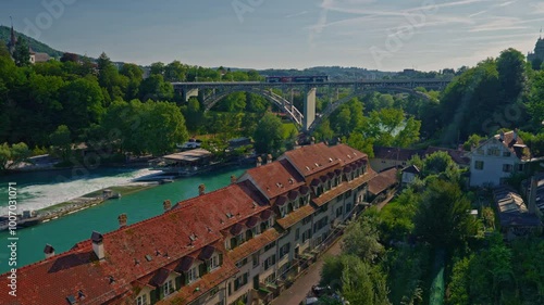 Bern medieval old town with a tramway and traditional red roofsdriving on the Kirchenfeld bridge above the Aar river in Switzerland capital city photo