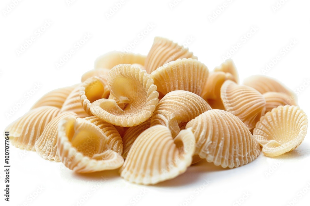 A pile of cooked pasta shells on a white surface A pile of cooked pasta shells on a white surface