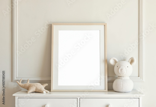 Empty wooden photo frame mockup on white furniture with beige wall and knitted animal toys for product display nursery interior background scandinavian style