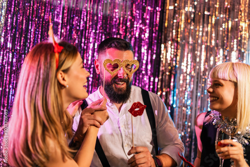 Three friends having fun with funny goggles at the New Years Eve party. photo