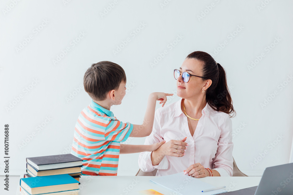 Female Teacher Teaching Boy On Laptop At School Online Female Teacher Teaching Boy On Laptop At School Online