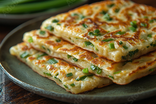 Savory scallion pancakes served in a rustic setting, showcasing their golden, flaky layers and fresh green toppings