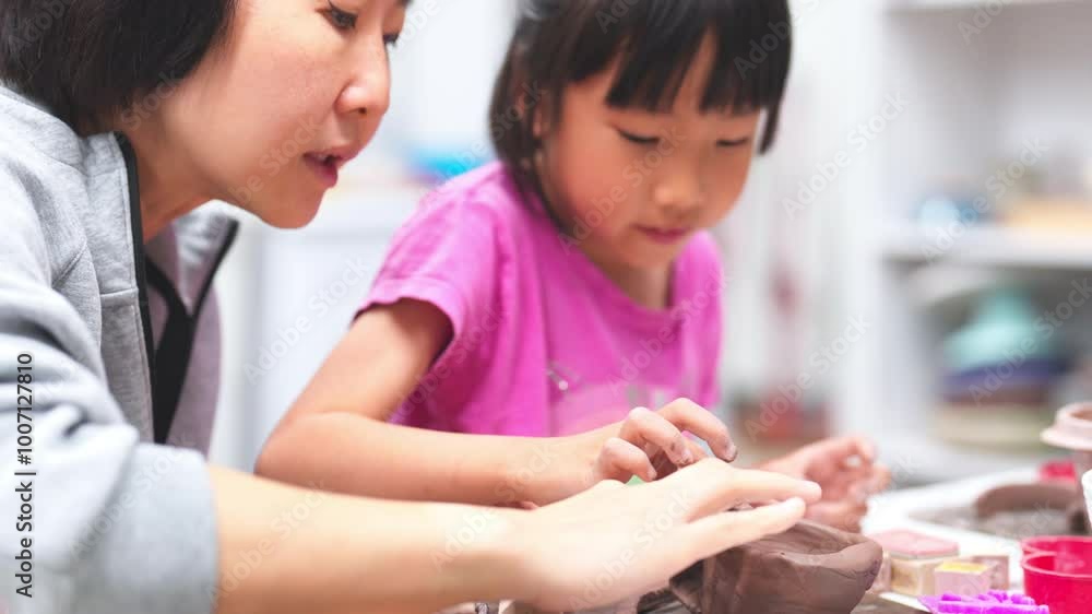 Young girl joyfully engaged in a pottery activity, carefully shaping a clay bowl with help of an instructor. Close-up capture shared moment of learning and creativity between the teacher and student. Young girl joyfully engaged in a pottery activity, carefully shaping a clay bowl with help of an instructor. Close-up capture shared moment of learning and creativity between the teacher and student.