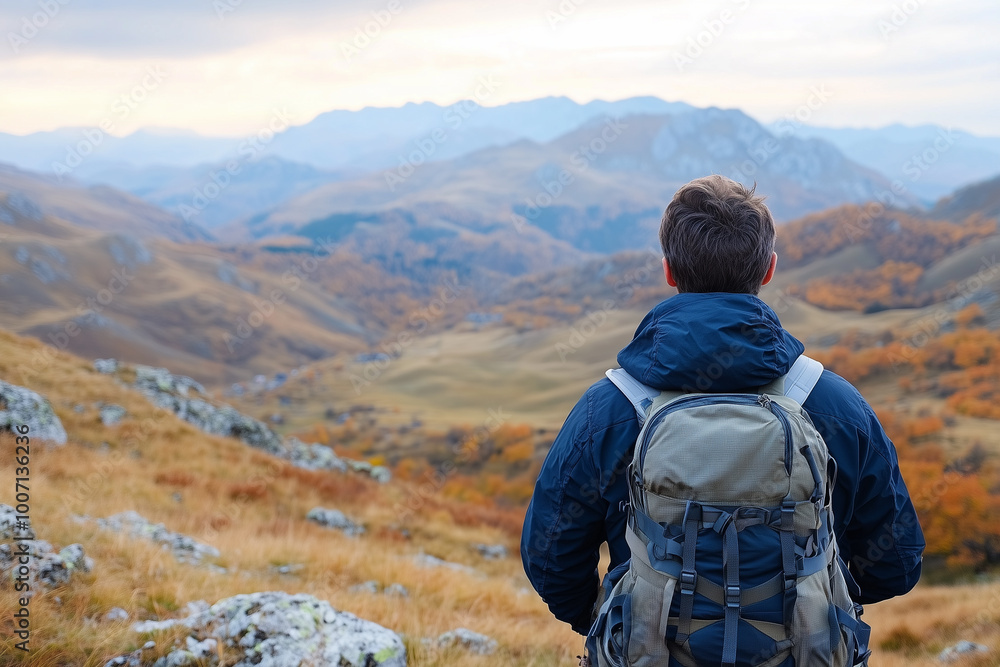 Back View of Male Hiker with Backpack Admiring Mountain Landscape, Outdoor Adventure in Autumn Back View of Male Hiker with Backpack Admiring Mountain Landscape, Outdoor Adventure in Autumn