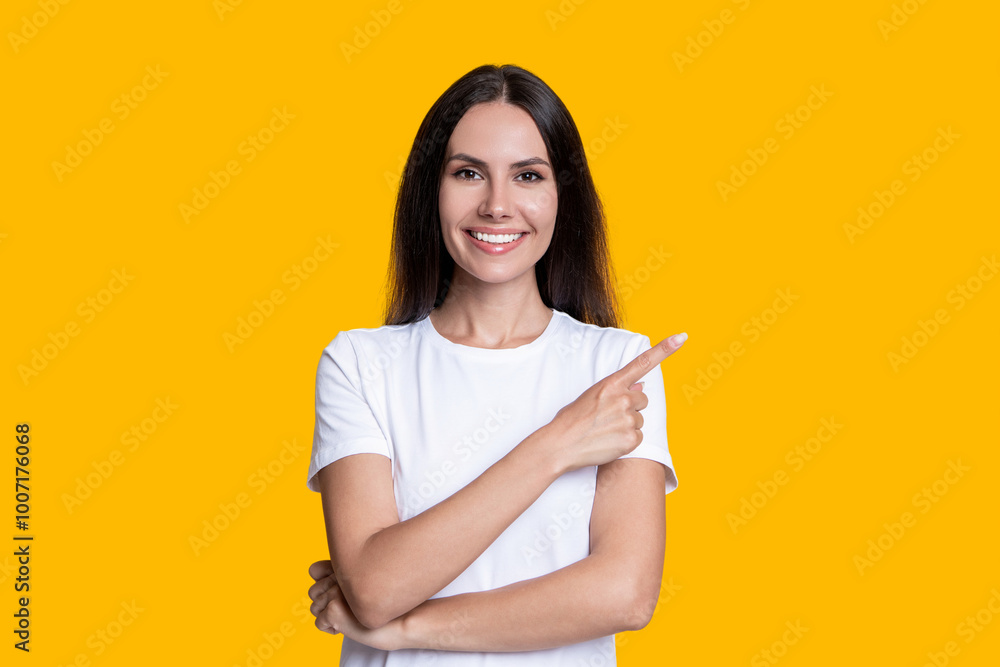 Stylish female. Advertisement offer. Portrait of millennial girl. Millennial girl presenting product. Woman in white tshirt isolated on yellow. Happy young woman point finger. Holiday sale offer Stylish female. Advertisement offer. Portrait of millennial girl. Millennial girl presenting product. Woman in white tshirt isolated on yellow. Happy young woman point finger. Holiday sale offer