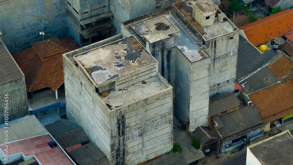 Aerial view capturing the raw industrial charm of weathered buildings amidst an urban landscape Aerial view capturing the raw industrial charm of weathered buildings amidst an urban landscape