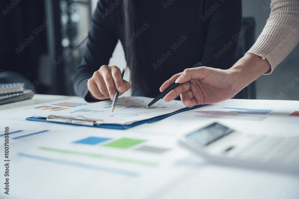 Strategic Collaboration: Close-up shot of two business professionals reviewing financial documents, showcasing teamwork and meticulous attention to detail. Strategic Collaboration: Close-up shot of two business professionals reviewing financial documents, showcasing teamwork and meticulous attention to detail.