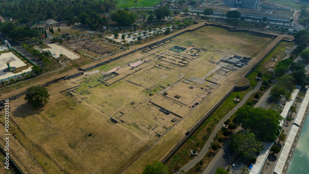 Fototapeta premium Aerial view showcasing the intricate layout of an ancient archaeological site bordered by modern development