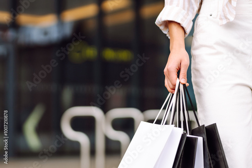 Autumn shopping. Happy woman with shopping bags walks through the city streets. 