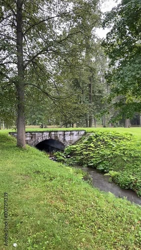 The old bridge in the park during the rain