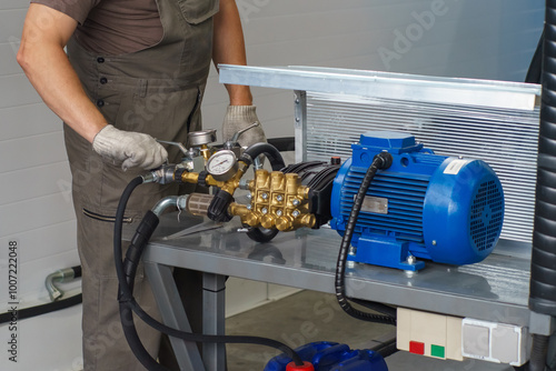 A man's hand in a white glove turns on a set with a pressure gauge for testing high pressure hydraulic hoses. A man in uniform is testing high pressure hoses. Pipe testing system.