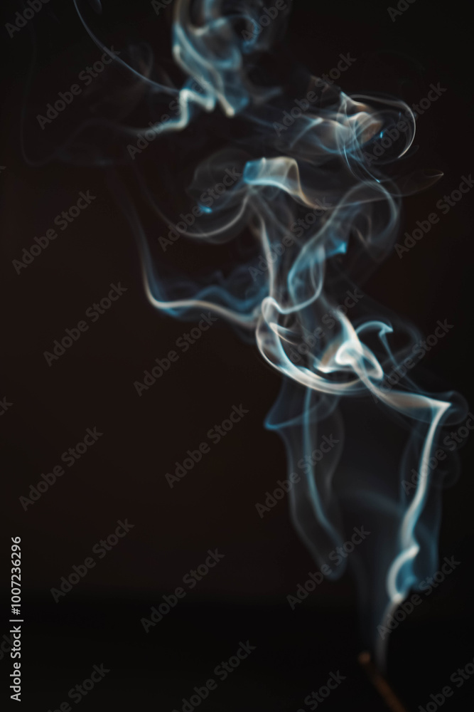 Aroma sticks smoke on black background with white backlit. Burning aromatic incense smoky stick for meditation and relaxing. Incense burning smoke fumes and wisps. Aromatherapy smokes for yoga. Aroma sticks smoke on black background with white backlit. Burning aromatic incense smoky stick for meditation and relaxing. Incense burning smoke fumes and wisps. Aromatherapy smokes for yoga.