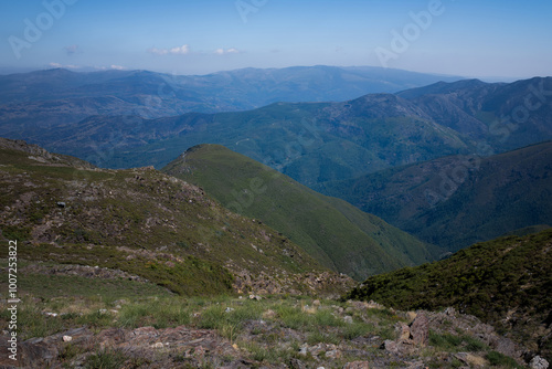 A panoramic view of the mountains in Portugal, showcasing the rugged beauty and vast landscapes under a clear sky.