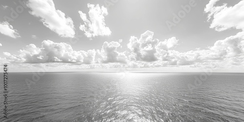 A dramatic black and white photo of the ocean waves crashing against the shore