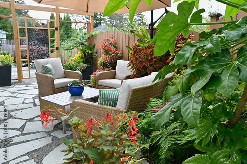 Fototapeta Naklejka Na Ścianę i Meble -  Outdoor tropical terraced patio in backyard garden for casual outdoor seating