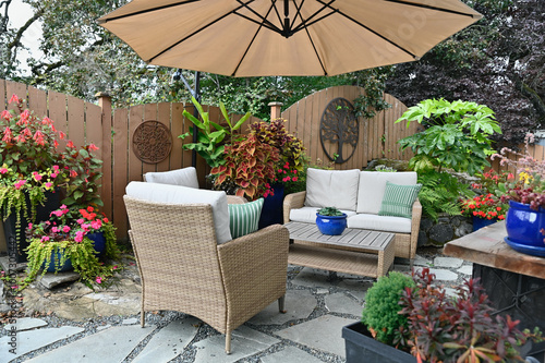 Outdoor mediterranean styled garden patio cafe space landscaped backyard seasonal oasis. 