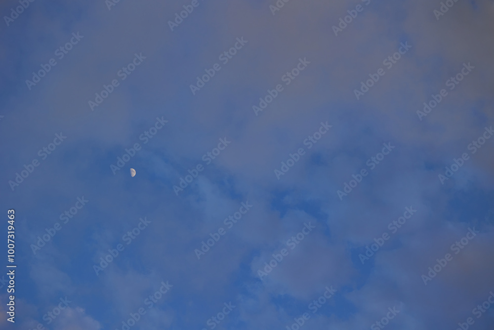 Moon on the cloudy sky before sunset Moon on the cloudy sky before sunset
