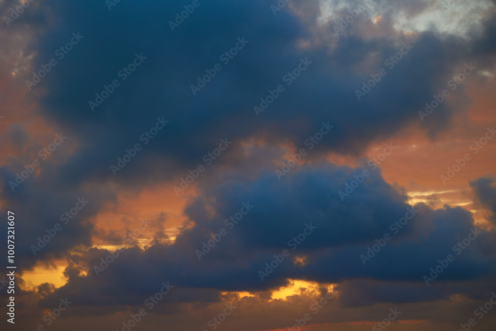 Wonderful view of the setting sun behind gray clouds Wonderful view of the setting sun behind gray clouds