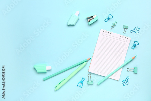 Wallpaper Mural Notebook with different stationery supplies on blue background Torontodigital.ca