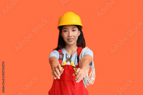 Young female electrician wi...