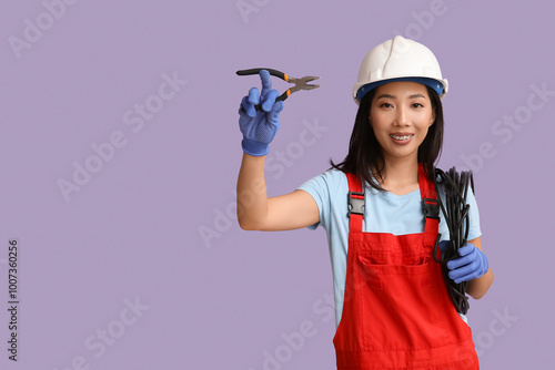 Young female electrician wi...